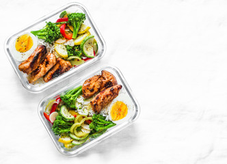 Rice, stewed vegetables, egg, teriyaki chicken - healthy balanced lunch box on a light background, top view. Home food for office concept. Copy space