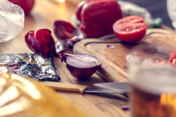 Chopping vegetables on a wooden board at home. Shallow depth of field.