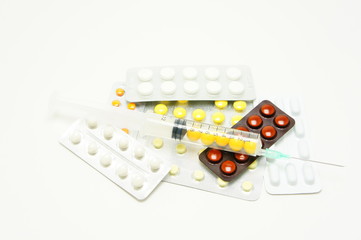 Medication. Syringe on packages of pills.