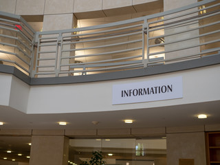 Plain information sign hanging in a large, modern room 