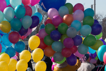 Fototapeta na wymiar Hand holding multicolored balloons birthday caucasian dress .