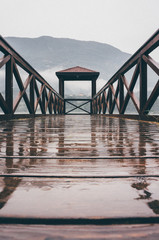 bridge over a lake in rainy day in summer