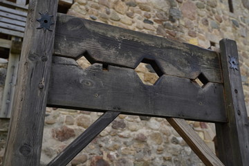 Empty wooden shackle for prisoners at a fortress yard