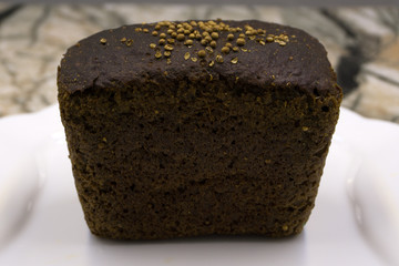 Russian bread, rye-wheat, Darnitsky on a light background.