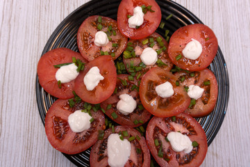 Healthy, fresh and delicious vegetable salad with cherry tomatoes, red onion rings, green pepper rings, parsley and olive oil .