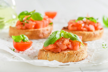 Closeup of homemade bruschetta with tomato and basil