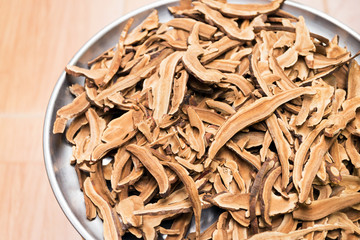 Dry ginseng roots sliced texture and background.