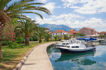 Picturesque Mediterranean town embankment with view of  fishing boats in harbor. Montenegro, Tivat city, Marina Kalimanj