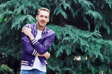 Man in the forest against green tree background