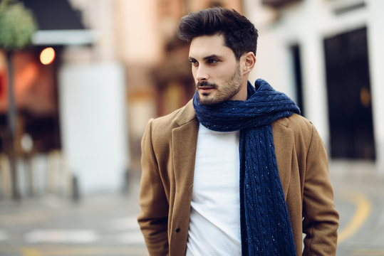 Young man wearing winter clothes in the street.