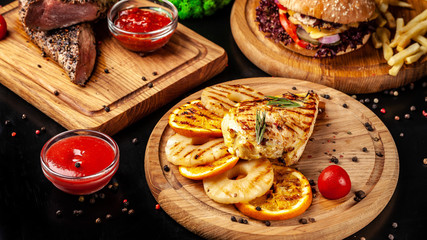 American fast food, burgers, french fries, meat and chicken steaks. Background image. set of several dishes. Copy space