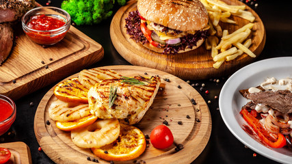 American fast food, burgers, french fries, meat and chicken steaks. Background image. set of several dishes. Copy space