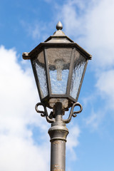 Fototapeta na wymiar street lantern light with blue sky and clouds