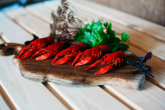 crayfish red boiled on a kitchen board with basil dill with a glass of beer