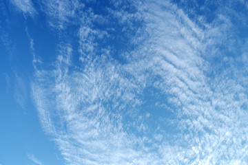Fototapeta na wymiar White fluffy clouds in the vast blue sky. Abstract nature background.
