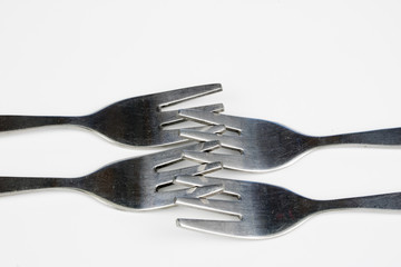 Cutlery arranged on a white kitchen table. Accessories for kitchen and restaurant use.