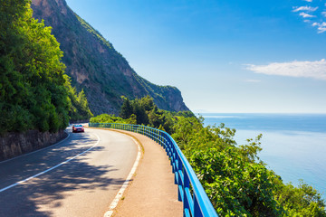 Asphalt curved road with car on the Adriatic sea coastline at Montenegro, vacations concept, nature landscape background