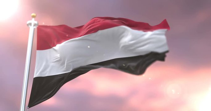 Flag of Yemen waving at wind in slow at sunset, loop
