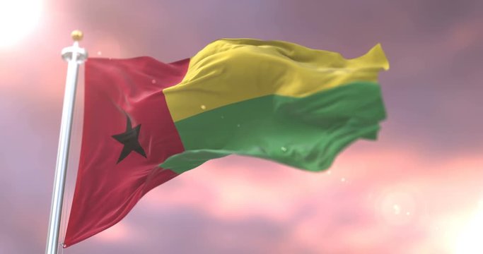 Flag of Guinea Bissau waving at wind in slow at sunset, loop