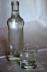 bouteille d'eau et verre avec glaçons 