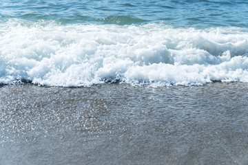 Foam wave surf at the sea coastline