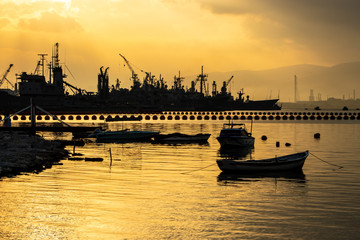 Navy town and fishing boat at sunset