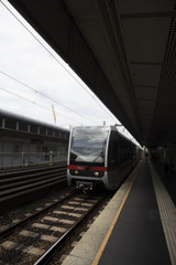 Naklejka premium Subway Station Outdoors With Train Approaching Its Stop