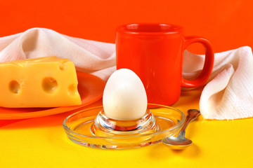 Still life with egg, cheese and orange mug