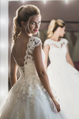 Beautiful bride near the mirror
