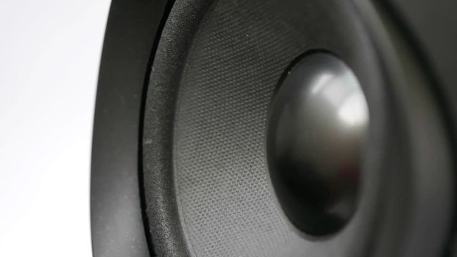 Detail of audio subwoofer loudspeaker membrane vibrating on bass sound during music recording in professional studio for dj playing loud rock remix tracks in the club