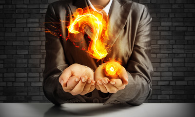 Businessman presenting question mark.
