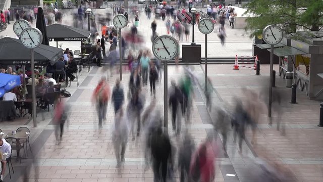 Fast motion timelapse of rush hours in London Canary Wharf district. Citizens, commuters and tourists crowd the streets and public transportation stations every day