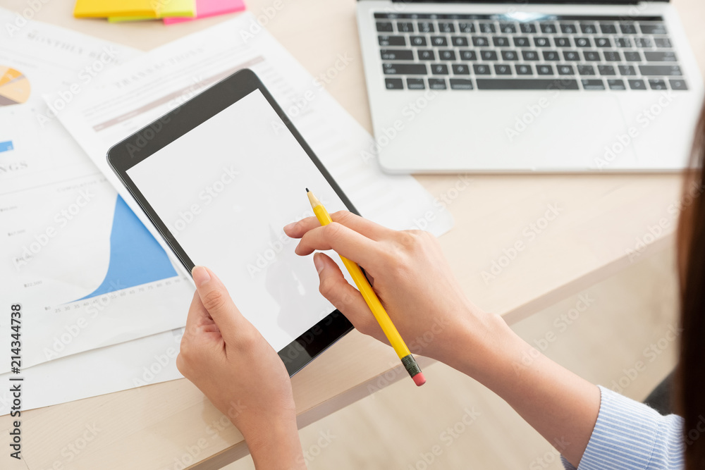 Poster Shoulder view of woman use tablet and  laptop working online on table at home.mock up template device screen.Digital lifestyle concept.clipping path screen.