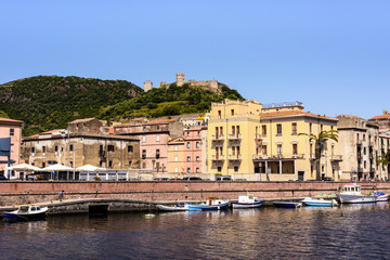 Naklejka na ściany i meble Mediterranean houses and Serravalle's castle on the shore of Tremo River in beautiful Bosa, Sardinia, Italy