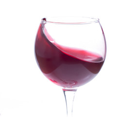 A glass with red wine on a white background. Isolate