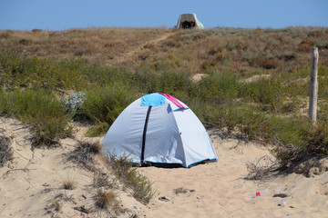 Tourist tent on the sand. Parking of tourists on the sandy beach