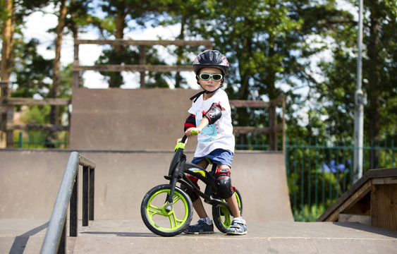 Happy boy on a runo with glasses, helmet and protective gear