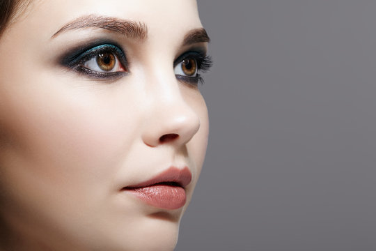 Closeup macro shot of  human female face. Woman with natural evening vogue face beauty makeup