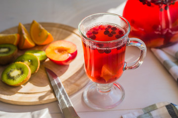 glass of cranberry drink and sliced fruit  - summer theme