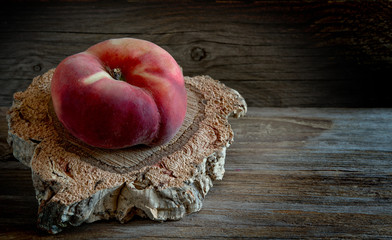 saturn peaches on wooden table.