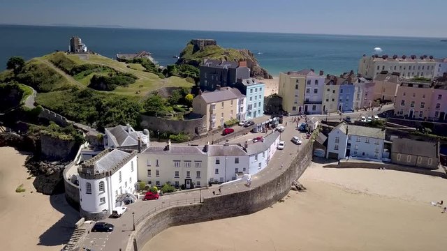 Aerial drone view of the historic Welsh seaside town of Tenby and its twin sandy beaches and medieval fort