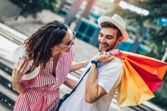 Couple having fun outdoor while doing shopping together