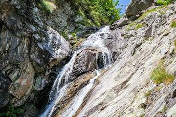 Fototapeta na wymiar Waterfall in an alpine valley