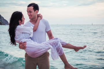 Happy honeymoon couple romantic in love at beach sunset.