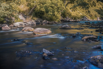 Fototapeta na wymiar Keila River flowing between rocks in the forest