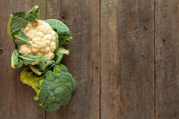 Fresh cauliflower and broccoli on wooden background. Top view, Copy space.