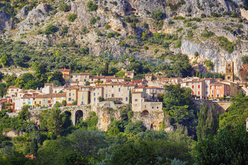 Fototapeta na wymiar French ancient city in Provence. Connected with the legend of the golden star stretching between the rocks. The city is one of the centers of French porcelain. Moustier St. Marie. France.