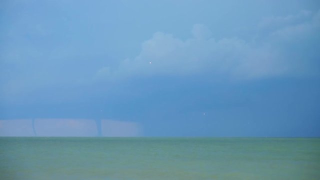 	Tornado and lightnings in the sky over the sea.