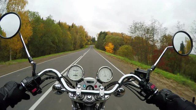 4K. Motorcycle riding on the beautiful forested road, wide point of view of rider. Classic cruiser/chopper forever! 