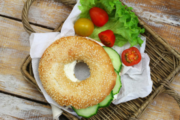 Sesame seed white bagel with cream cheese and cucumber
